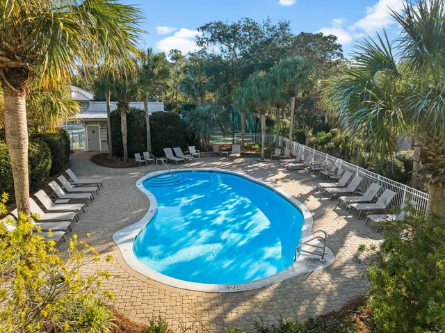 a swimming pool with outdoor seating and yard