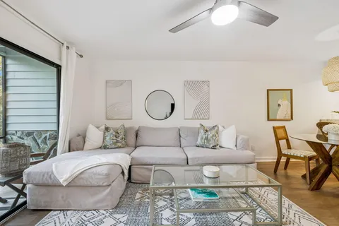 a living room with furniture and a chandelier
