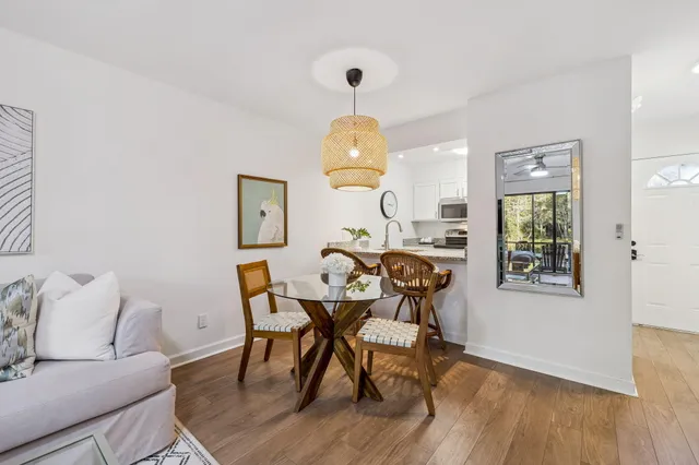 a kitchen with granite countertop a stove a sink and a microwave