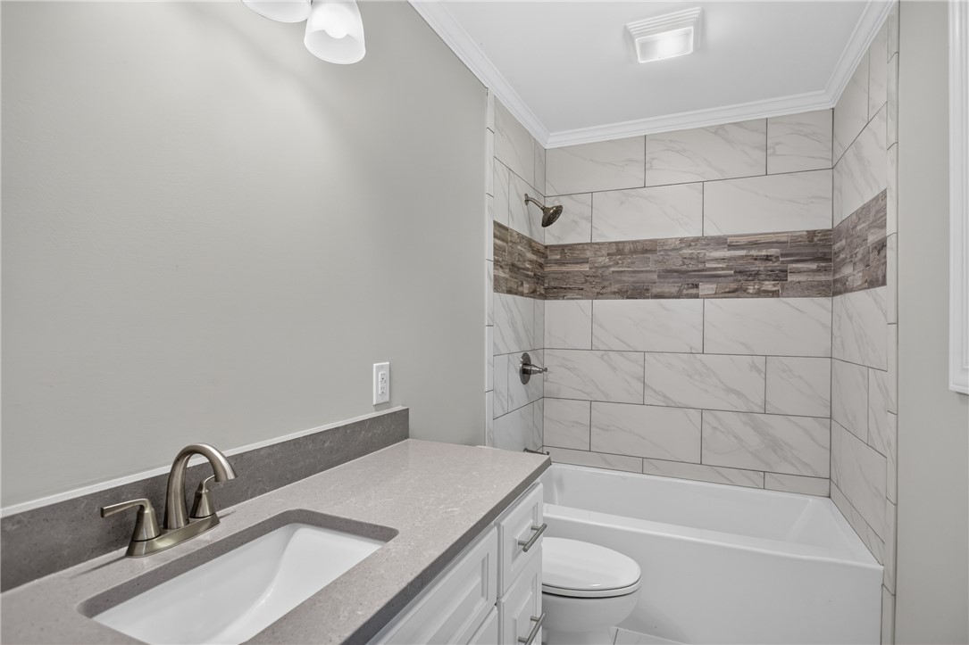712 Beech Drive Seneca, SC 29678 - Photo 23 of 41 A refined bathroom featuring a contemporary vanity and a tiled shower-tub combination.