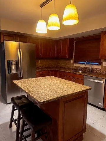 a kitchen with cabinets and chandelier