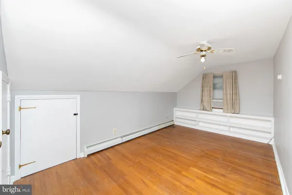 a view of a room with a window and a ceiling fan