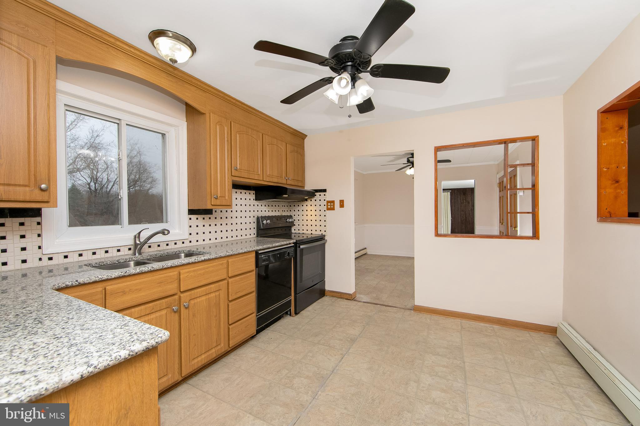 126 Trewigtown Road Chalfont, PA 18914 - Photo 2 of 15 a kitchen with stainless steel appliances granite countertop a sink a stove and a refrigerator