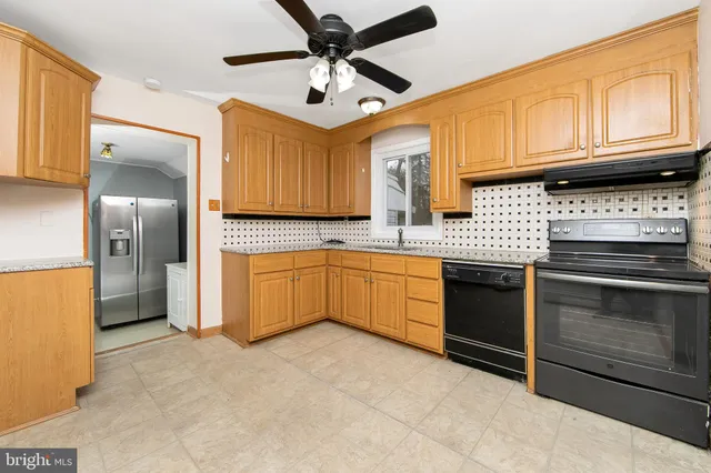 a kitchen with stainless steel appliances granite countertop a stove sink and refrigerator