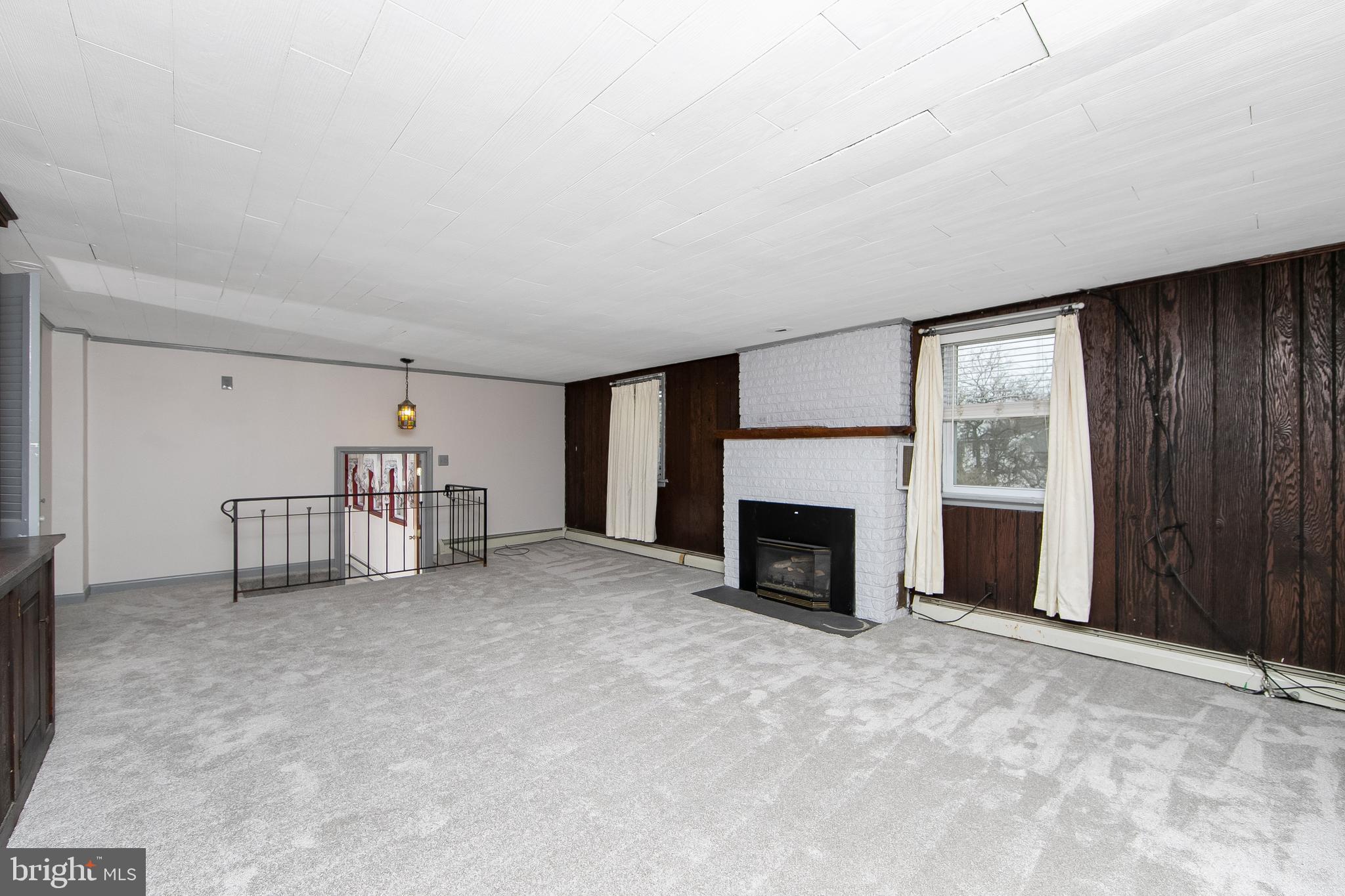 126 Trewigtown Road Chalfont, PA 18914 - Photo 6 of 15 a view of a livingroom with a fireplace cabinet and windows