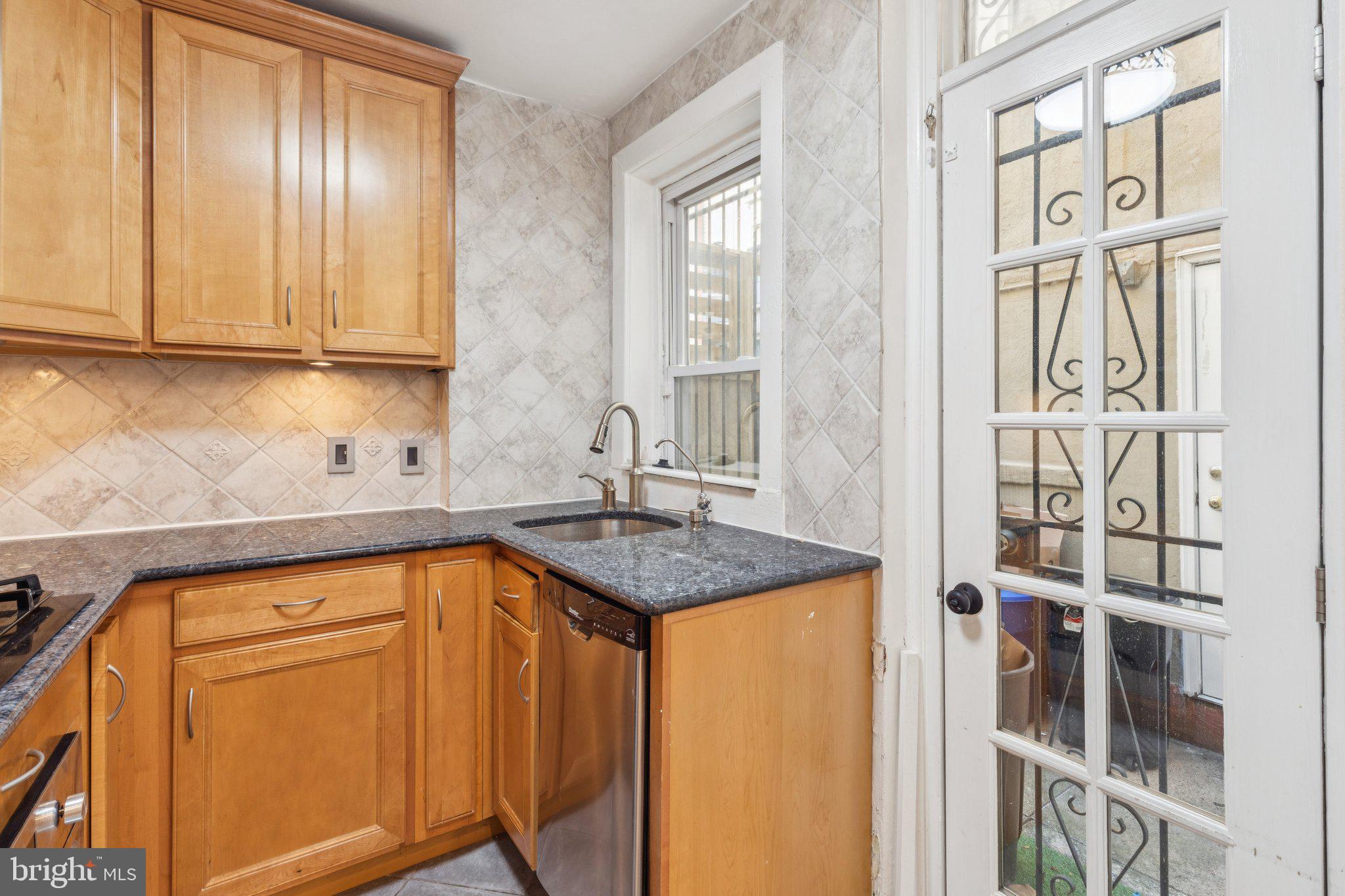 1830 R Manning Street, Unit 2 Philadelphia, PA 19103 - Photo 12 of 32 a kitchen with stainless steel appliances granite countertop a sink and cabinets
