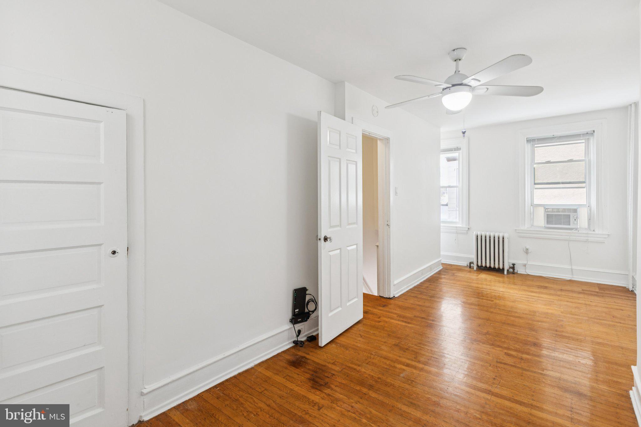 1830 R Manning Street, Unit 2 Philadelphia, PA 19103 - Photo 18 of 32 a view of an empty room with window and wooden floor