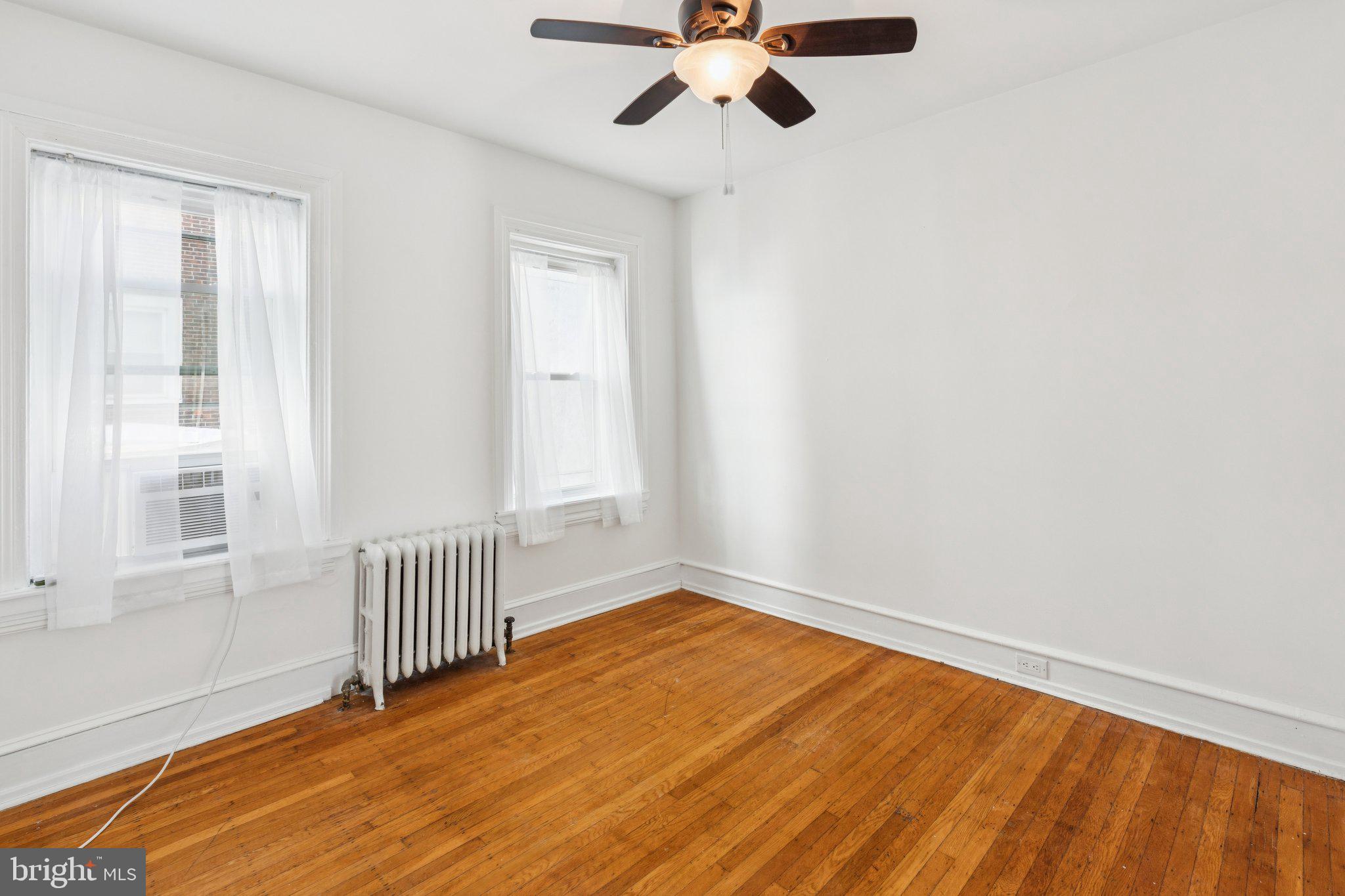 1830 R Manning Street, Unit 2 Philadelphia, PA 19103 - Photo 19 of 32 an empty room with a window and a ceiling fan