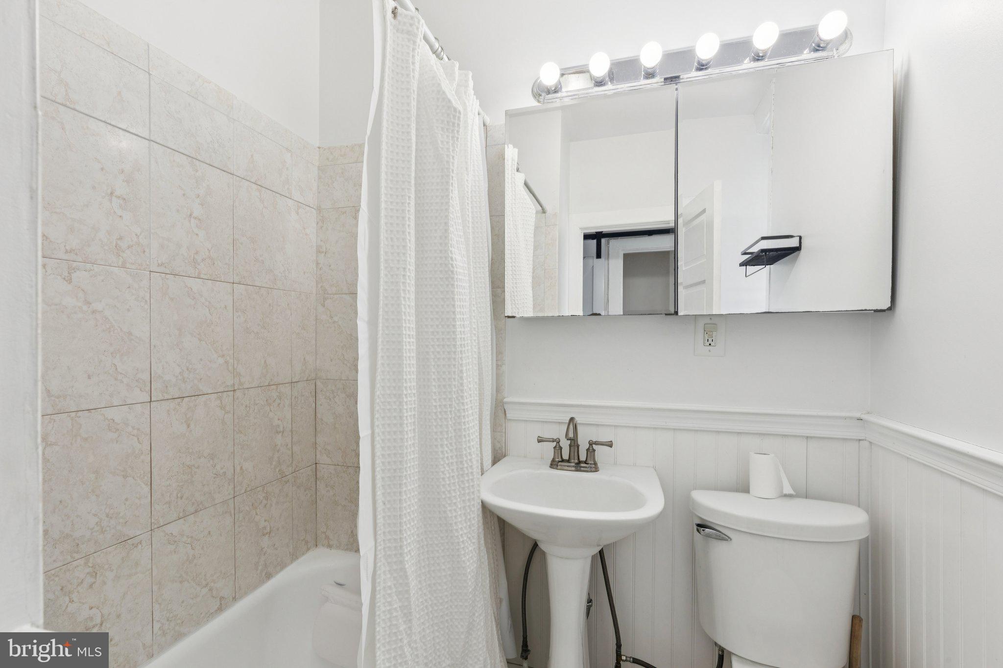 1830 R Manning Street, Unit 2 Philadelphia, PA 19103 - Photo 22 of 32 a bathroom with a sink a toilet and bathtub