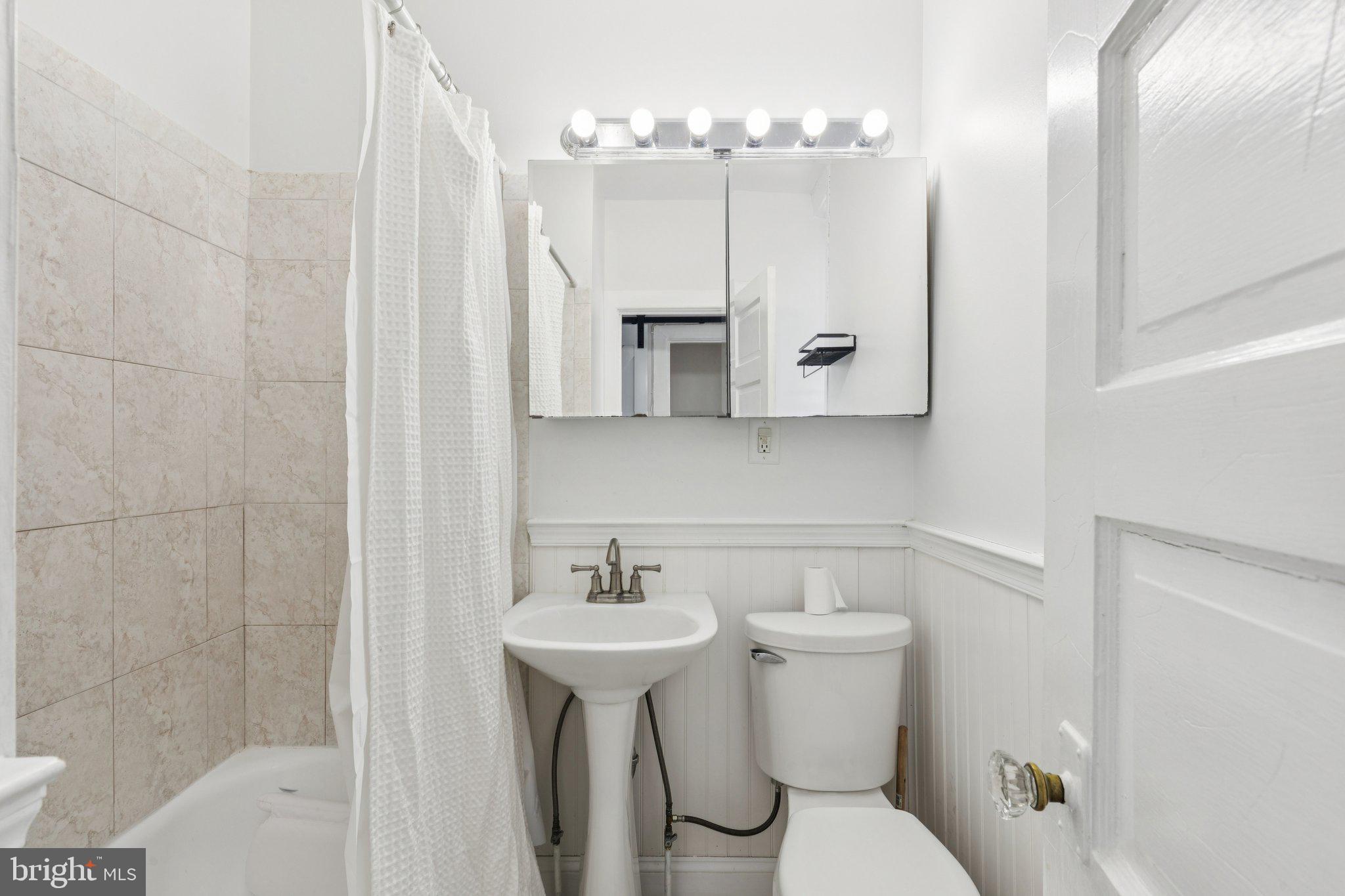 1830 R Manning Street, Unit 2 Philadelphia, PA 19103 - Photo 23 of 32 a bathroom with a sink toilet mirror and shower