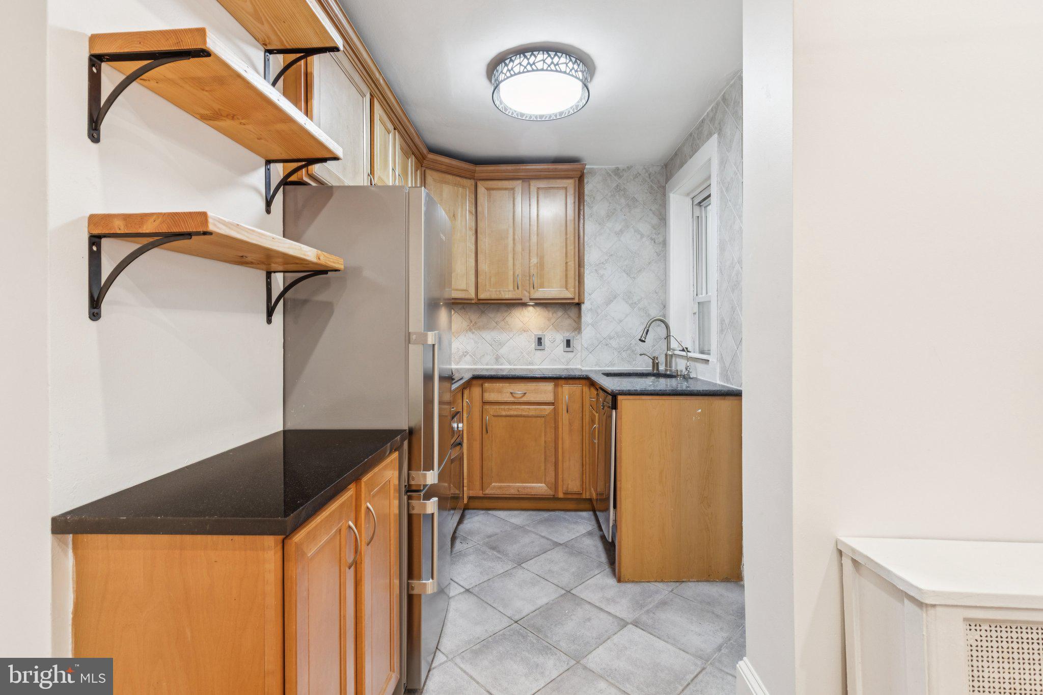 1830 R Manning Street, Unit 2 Philadelphia, PA 19103 - Photo 9 of 32 a kitchen with a refrigerator a sink and a stove