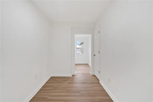 a view of a hallway with wooden floor