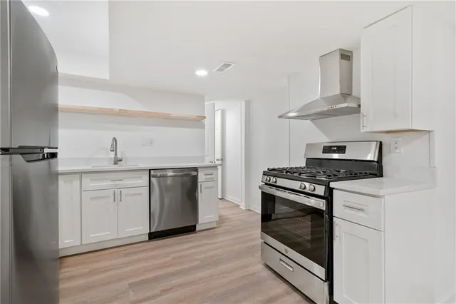 a kitchen with a stove top oven and cabinets