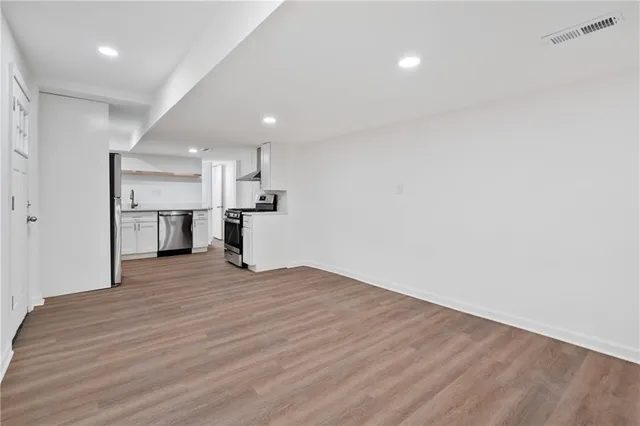 a view of a kitchen with a sink and a refrigerator
