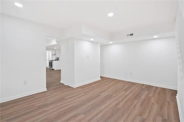 a view of a room with wooden floor
