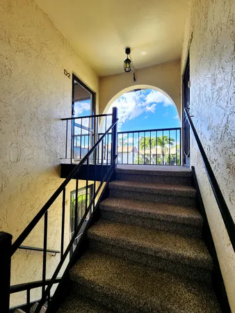 a view of staircase with wooden floor and a window