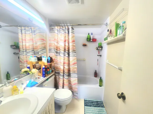 a bathroom with a sink toilet and shower