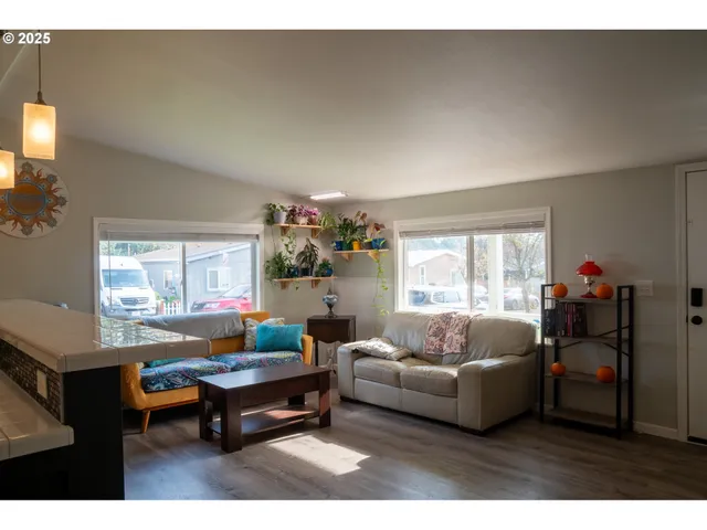 a living room with furniture and a potted plant