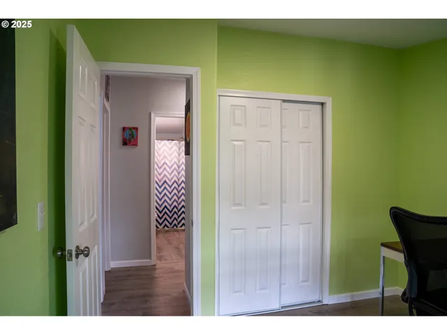 a view of a room with a window and a chair