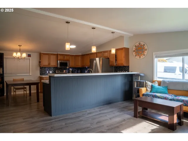 a living room with kitchen island furniture and a wooden floor