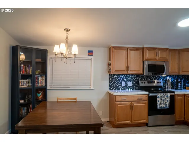 a kitchen with stainless steel appliances granite countertop a stove and a sink