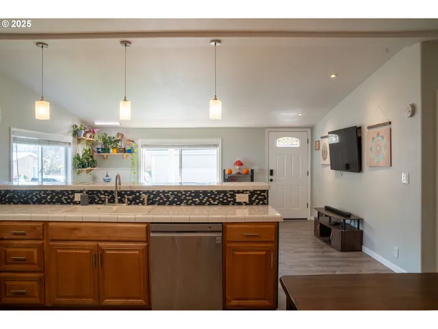 a kitchen with kitchen island a counter space a sink and appliances