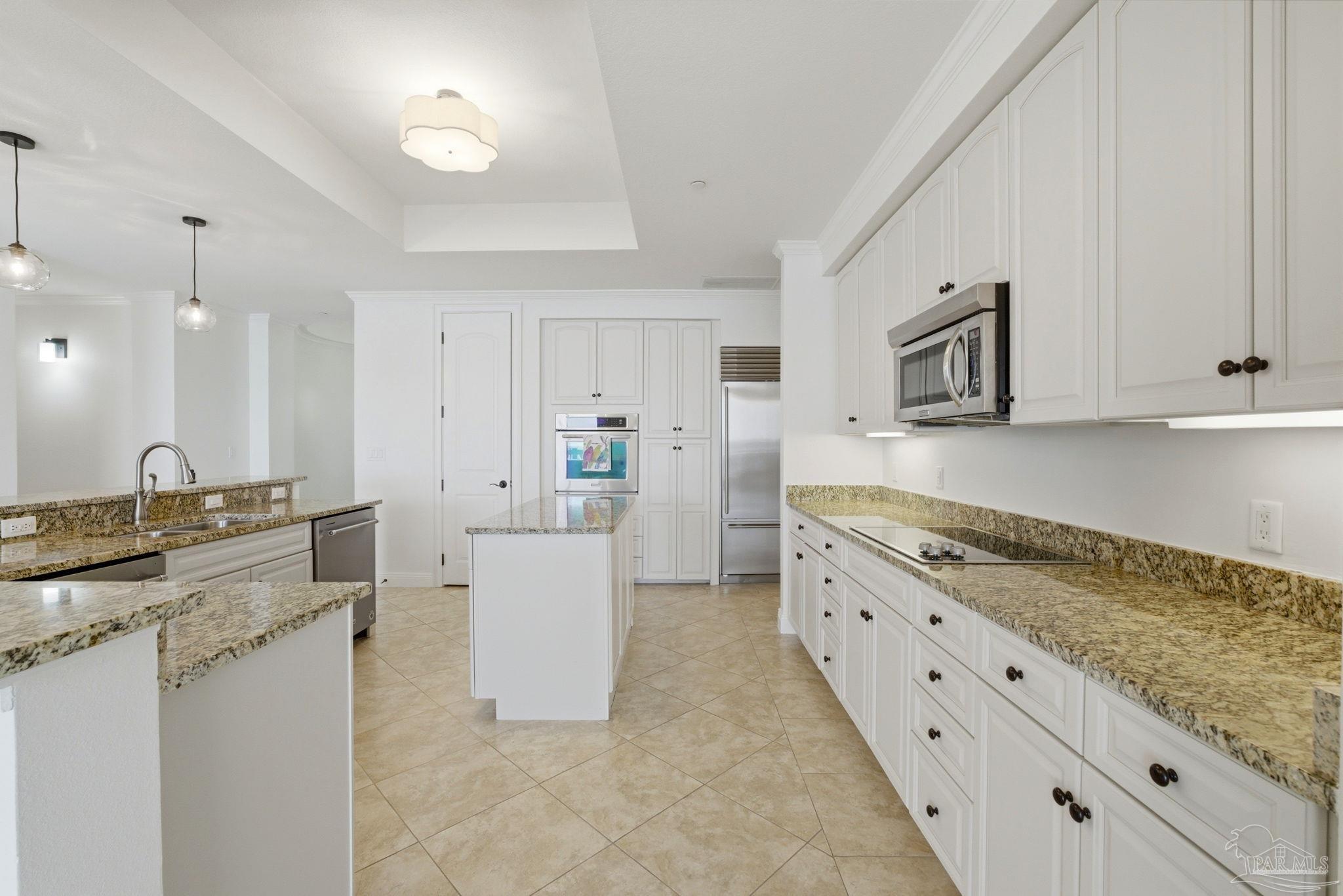 14500 River Road, Unit 504 Perdido Key, FL 32507 - Photo 13 of 61 a large white kitchen with granite countertop a sink white cabinets and stainless steel appliances