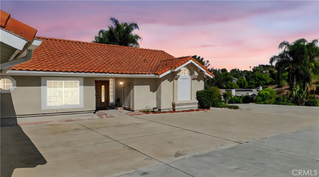 11056 Orchard View Lane Riverside, CA 92503 - Photo 1 of 50 a front view of a house with a garden and mountain view
