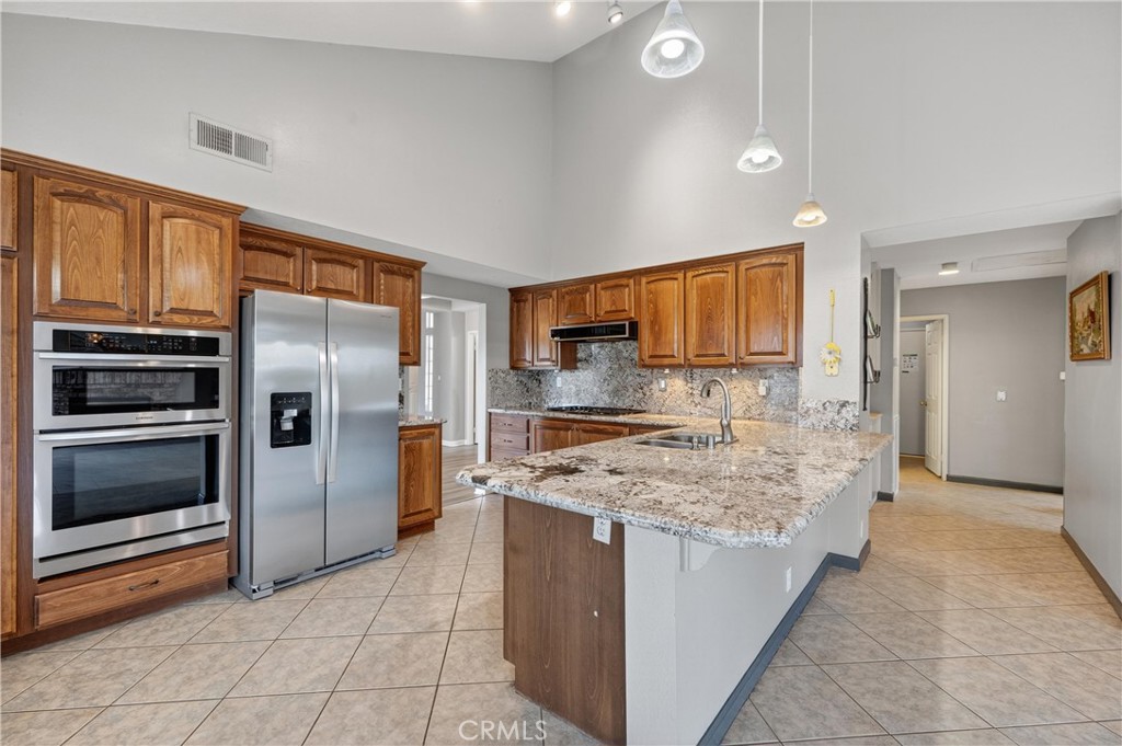 11056 Orchard View Lane Riverside, CA 92503 - Photo 13 of 50 a kitchen with stainless steel appliances granite countertop a stove oven and refrigerator