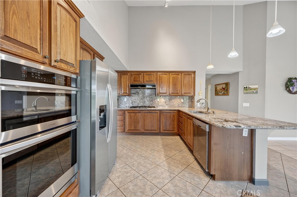 11056 Orchard View Lane Riverside, CA 92503 - Photo 14 of 50 a kitchen with stainless steel appliances a sink and cabinets