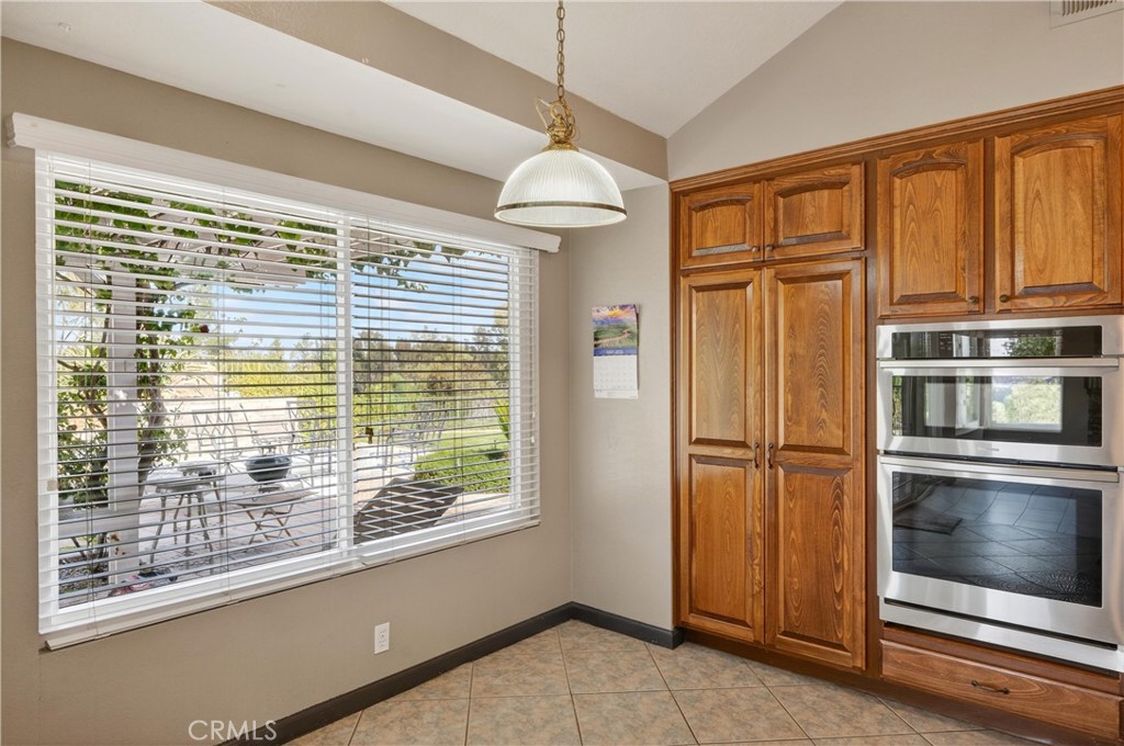 11056 Orchard View Lane Riverside, CA 92503 - Photo 16 of 50 a view of a kitchen with a stove fridge and wooden floor