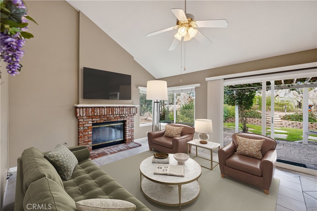 11056 Orchard View Lane Riverside, CA 92503 - Photo 18 of 50 a living room with furniture a fireplace and a flat screen tv
