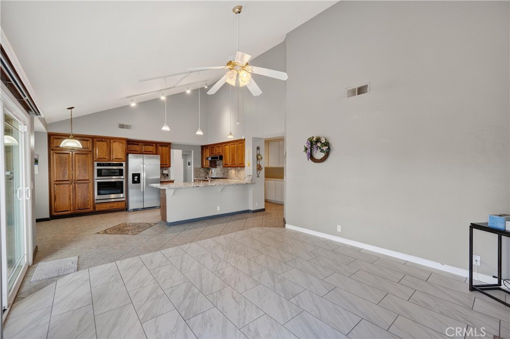 11056 Orchard View Lane Riverside, CA 92503 - Photo 19 of 50 a view of a kitchen with a sink cabinet a refrigerator and window