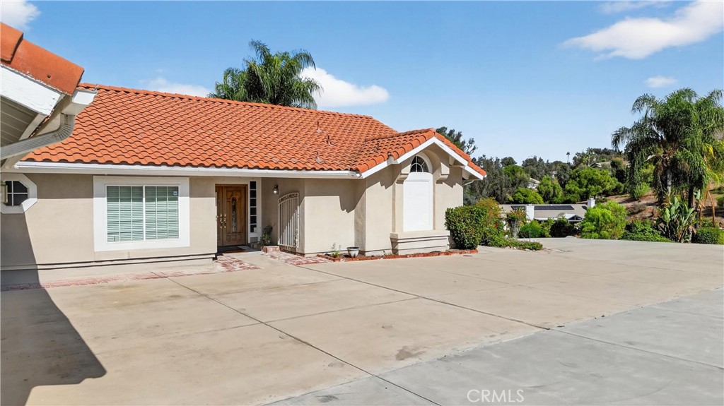 11056 Orchard View Lane Riverside, CA 92503 - Photo 2 of 50 a front view of a house with a garden and pathway