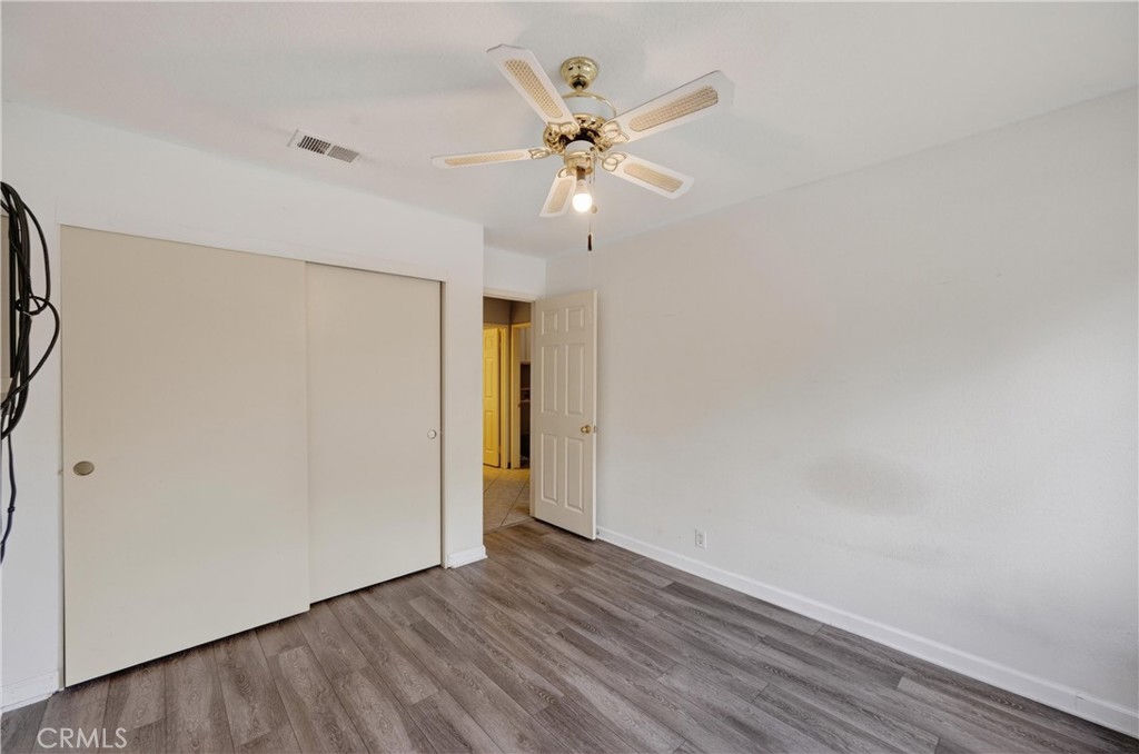 11056 Orchard View Lane Riverside, CA 92503 - Photo 23 of 50 a view of an empty room with wooden floor and a ceiling fan