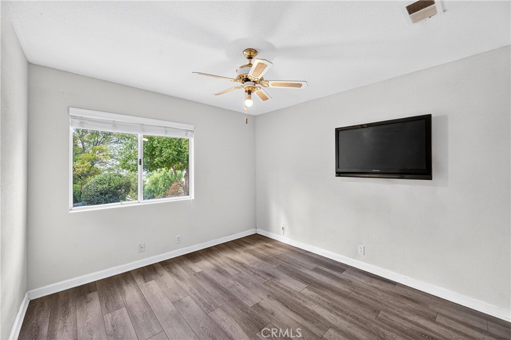 11056 Orchard View Lane Riverside, CA 92503 - Photo 24 of 50 wooden floor in an empty room with a window and a flat screen tv