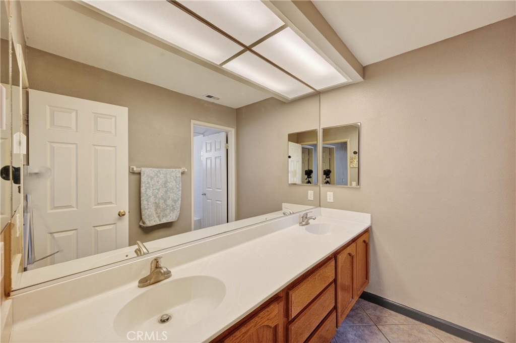 11056 Orchard View Lane Riverside, CA 92503 - Photo 28 of 50 a bathroom with a sink and a mirror