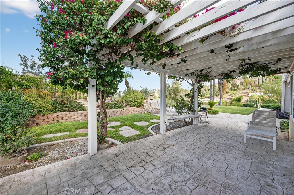 11056 Orchard View Lane Riverside, CA 92503 - Photo 36 of 50 a view of a backyard with couches under an umbrella