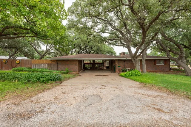 a front view of a house with a yard and a garage