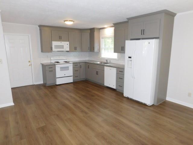 879 Forest Ridge Drive Southeast Marietta, GA 30067 - Photo 20 of 29 a kitchen with a refrigerator a stove top oven and white cabinets