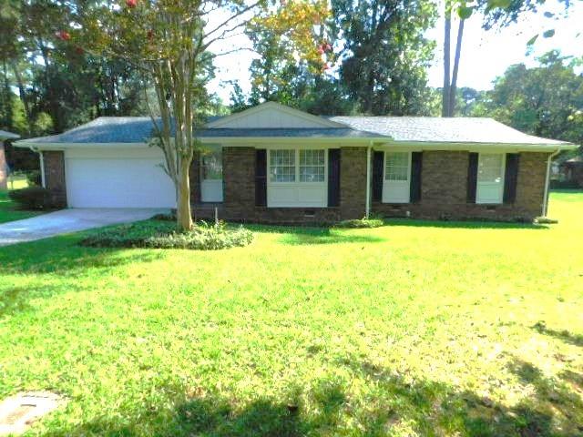 879 Forest Ridge Drive Southeast Marietta, GA 30067 - Photo 2 of 29 a front view of a house with a yard