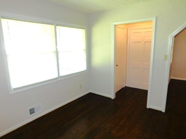 879 Forest Ridge Drive Southeast Marietta, GA 30067 - Photo 3 of 29 an empty room with wooden floor and windows