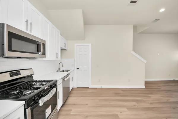 a kitchen with a stove and a microwave