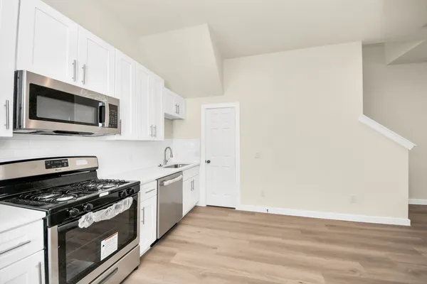 a view of a kitchen from the hallway