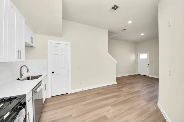a kitchen with a sink cabinets and stainless steel appliances