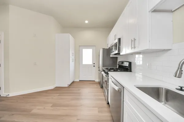 a kitchen with stainless steel appliances granite countertop a stove and a refrigerator