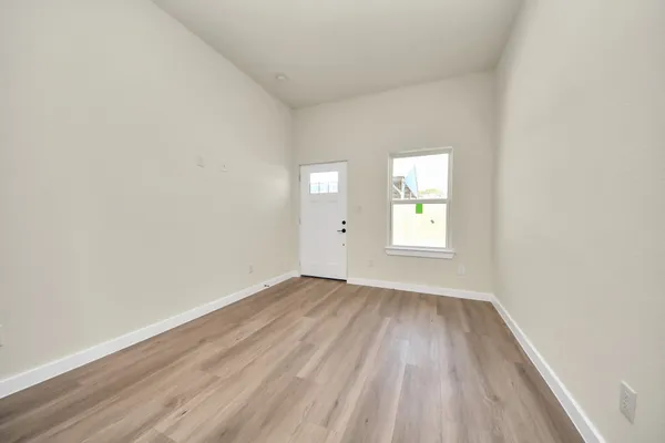 a view of a kitchen with wooden floor and electronic appliances