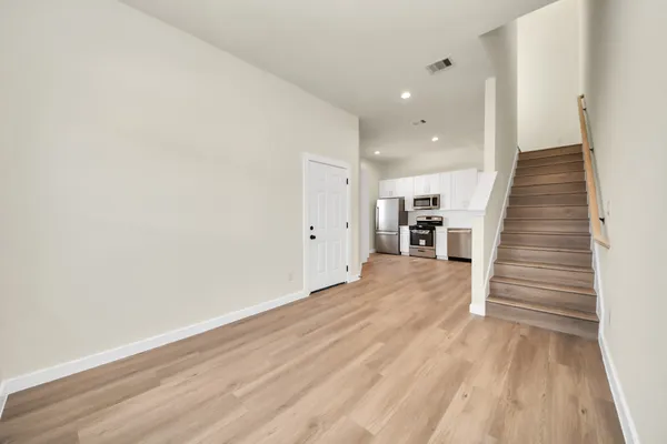 a kitchen with granite countertop white cabinets and stainless steel appliances