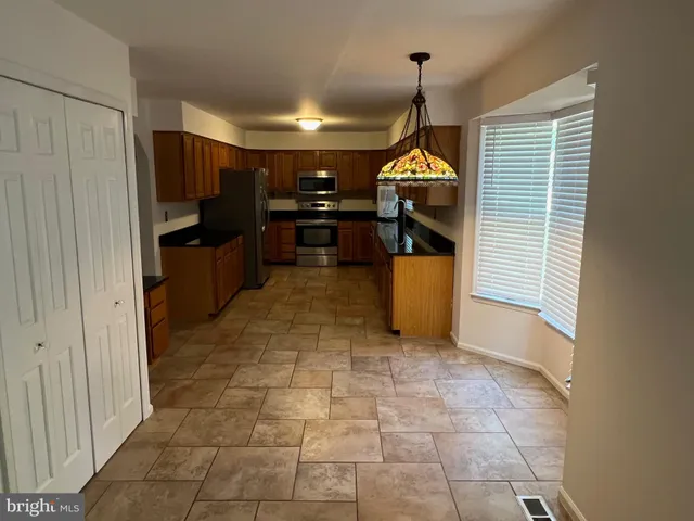 a view of a kitchen from the hallway