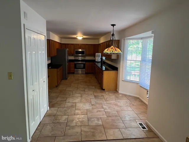 a kitchen with stainless steel appliances a refrigerator and a stove